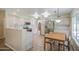 Bright kitchen with stainless steel appliances, white cabinets and a cozy table at 1720 W Orchid Ln, Chandler, AZ 85224