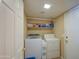 Functional laundry room equipped with washer, dryer, and ample storage space on shelving at 1720 W Orchid Ln, Chandler, AZ 85224