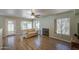 Living room with a fireplace and large window, wood floors and neutral walls at 1720 W Orchid Ln, Chandler, AZ 85224