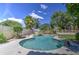 Backyard pool features rock waterfall, lush landscaping, and privacy at 1720 W Orchid Ln, Chandler, AZ 85224