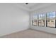 Bright bedroom featuring carpet, white walls, large windows, and an airy atmosphere at 20308 W Montecito Ave, Buckeye, AZ 85396