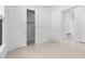 Neutral bedroom with tile flooring, closet, white walls, and doorway to the entryway at 20308 W Montecito Ave, Buckeye, AZ 85396
