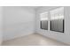 A well-lit room featuring neutral tile flooring, white walls, and windows with views of the outdoors at 20308 W Montecito Ave, Buckeye, AZ 85396