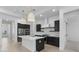 Modern kitchen features a center island with stainless steel appliances and dark cabinets at 20308 W Montecito Ave, Buckeye, AZ 85396