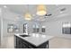 Bright, open kitchen with island, pendant lights, and an adjacent area with large windows at 20308 W Montecito Ave, Buckeye, AZ 85396