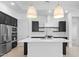 Spacious modern kitchen with stainless steel appliances, dark cabinets, and a center island at 20308 W Montecito Ave, Buckeye, AZ 85396