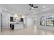 Open concept kitchen and bright living area with large windows and tile flooring at 20308 W Montecito Ave, Buckeye, AZ 85396