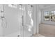 Contemporary shower with white tile, glass door, and built-in seating for a spa-like experience at 20308 W Montecito Ave, Buckeye, AZ 85396