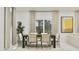 Elegant dining area featuring stylish table set with a large window and views of the outdoor landscape at 20900 S 231St Way, Queen Creek, AZ 85142