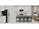 Modern kitchen features an island with breakfast bar seating, stainless steel appliances, and ample counter space at 20900 S 231St Way, Queen Creek, AZ 85142