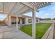 Inviting backyard featuring a well-maintained lawn and a charming covered patio area, perfect for outdoor relaxation at 21325 S 201St Way, Queen Creek, AZ 85142