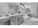 Bright bathroom featuring dual sinks, a soaking tub, and tasteful gray cabinetry at 21325 S 201St Way, Queen Creek, AZ 85142