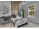 Neutral bedroom with wood accent wall, modern decor, and natural light at 21325 S 201St Way, Queen Creek, AZ 85142