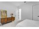Bright bedroom featuring minimalist decor, clean white walls, and a decorative dresser at 21325 S 201St Way, Queen Creek, AZ 85142