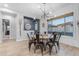 Bright dining room with stylish light fixture, large window, and seating for six people at 21325 S 201St Way, Queen Creek, AZ 85142