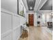 Welcoming foyer with hardwood floors, custom wall paneling, and a stylish, modern light at 21325 S 201St Way, Queen Creek, AZ 85142