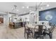 Bright open kitchen and dining area with stylish light fixtures and white cabinetry at 21325 S 201St Way, Queen Creek, AZ 85142