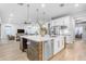 Open-concept kitchen with a large island, stainless steel appliances, and modern pendant lighting at 21325 S 201St Way, Queen Creek, AZ 85142