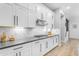 Gourmet kitchen with sleek white cabinets, quartz countertops, and stainless steel appliances at 21325 S 201St Way, Queen Creek, AZ 85142