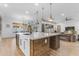 Open concept kitchen with island featuring bar seating and views into the living room at 21325 S 201St Way, Queen Creek, AZ 85142