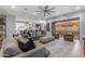 Open-concept living room with access to backyard, with neutral furniture and modern decor at 21325 S 201St Way, Queen Creek, AZ 85142