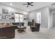 Inviting living room with plush gray sectional, modern furniture, and decor at 21325 S 201St Way, Queen Creek, AZ 85142
