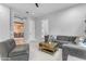 Bright living room featuring a gray sectional and view to a dining area at 21325 S 201St Way, Queen Creek, AZ 85142