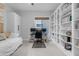 Bright and modern home office featuring built in bookshelves and natural light at 21325 S 201St Way, Queen Creek, AZ 85142