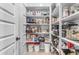 Walk-in pantry with ample shelving, organized storage and patterned wallpaper at 21325 S 201St Way, Queen Creek, AZ 85142