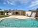 Inviting backyard with a sparkling pool, covered patio, and well-maintained landscaping for outdoor enjoyment at 2201 W Avalon Dr, Phoenix, AZ 85015