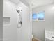 Bathroom featuring a tiled shower with a niche, a rain shower head, and modern fixtures at 2201 W Avalon Dr, Phoenix, AZ 85015