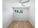 Bright bedroom with wood floors, a ceiling fan, and a window offering natural light at 2201 W Avalon Dr, Phoenix, AZ 85015