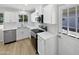Modern kitchen featuring white cabinets, stainless steel appliances, and bright natural light at 2201 W Avalon Dr, Phoenix, AZ 85015