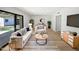 Bright living room with modern decor, including plush seating, stylish rug, and sliding doors for natural light at 2201 W Avalon Dr, Phoenix, AZ 85015