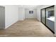 Spacious living room with a large sliding glass door and sleek wood flooring at 2201 W Avalon Dr, Phoenix, AZ 85015