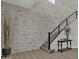 Contemporary staircase with brick accent wall, black metal railings, and light carpet on the stairs at 2522 E Presidio St, Mesa, AZ 85213