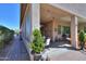 Cozy covered back patio with ample seating area, brick pavers, and lush greenery at 2623 E Marcos Dr, Casa Grande, AZ 85194