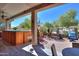 Charming covered patio with a hot tub and a view of the backyard's desert landscaping at 2623 E Marcos Dr, Casa Grande, AZ 85194