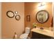 Powder room with single sink, decorative mirror, and stylish wall accessories at 2623 E Marcos Dr, Casa Grande, AZ 85194