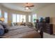 Well-lit bedroom with carpet, a ceiling fan, and large windows with plantation shutters at 2623 E Marcos Dr, Casa Grande, AZ 85194