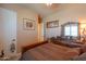 Bedroom featuring patterned bedding, wood furniture and a decorative, detailed wall mirror at 2623 E Marcos Dr, Casa Grande, AZ 85194