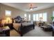 Bedroom featuring a large bed, carpeted floors, many windows, and beautiful decor at 2623 E Marcos Dr, Casa Grande, AZ 85194