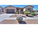Charming single-Gathering home with a well-manicured front yard, desert landscaping, and a two-car garage at 2623 E Marcos Dr, Casa Grande, AZ 85194