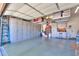 Garage featuring built-in cabinets, storage racks, and epoxy flooring at 2623 E Marcos Dr, Casa Grande, AZ 85194
