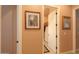 Hallway displays light-colored walls, decorative paintings, and doorways leading to rooms at 2623 E Marcos Dr, Casa Grande, AZ 85194