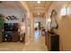 Inviting hallway with neutral paint, tile flooring, decorative mirrors, and entry to the living spaces at 2623 E Marcos Dr, Casa Grande, AZ 85194