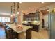 Kitchen with stainless steel appliances, granite countertops, dark wood cabinetry, and large island at 2623 E Marcos Dr, Casa Grande, AZ 85194