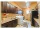 Spacious laundry room with ample cabinetry, sink, washer, and dryer at 2623 E Marcos Dr, Casa Grande, AZ 85194