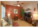 Comfortable living room featuring a ceiling fan, wall art, a plush sofa, and entertainment center at 2623 E Marcos Dr, Casa Grande, AZ 85194