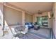 Covered patio area featuring comfortable seating, a ceiling fan, and a view to the back yard at 2623 E Marcos Dr, Casa Grande, AZ 85194